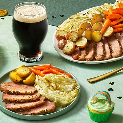 Featuring stout beer, boiled dinner with corned beef, cabbage, potatoes and carrots, and green themed cupcakes