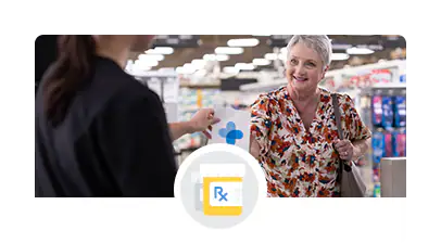 A happy customer receiving a prescription from a kind pharmacist.